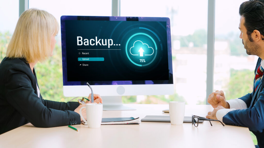 Cloud-Symbol mit integriertem Dateiordner neben einem Laptop
